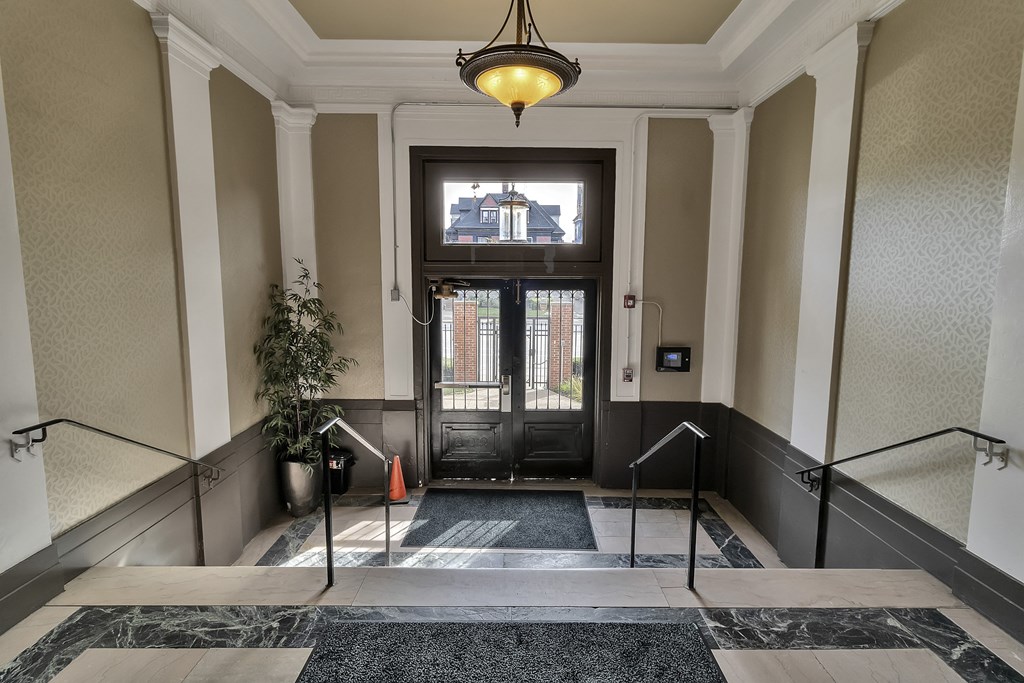 a lobby with stairs and a glass door at The Knights @ 506 Delaware Apartments, New York, 14202
