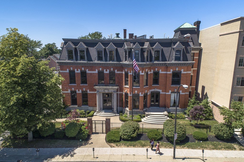 an aerial view of a brick building with an flag at The Knights @ 506 Delaware Apartments, New York, 14202