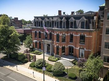 A large brick building with a flag on the front.