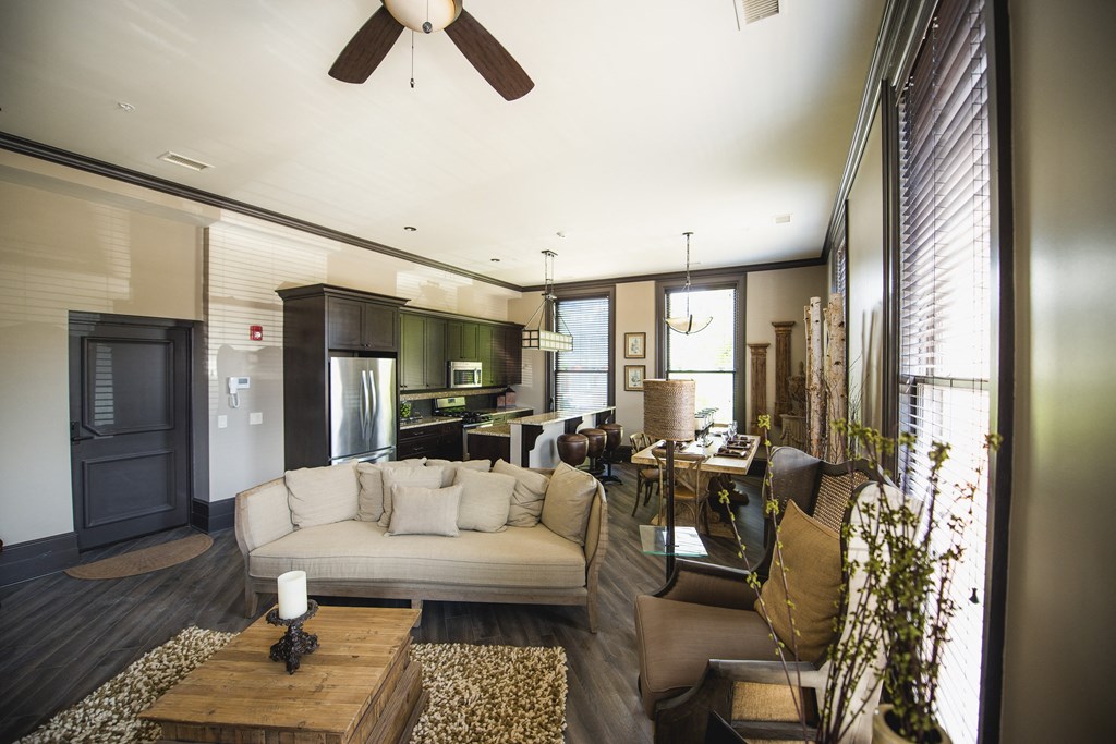 a living room and kitchen with a couch and a table at The Knights @ 506 Delaware Apartments, New York, 14202