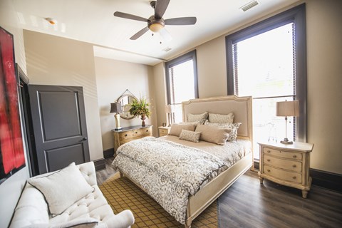 a bedroom with a bed and a ceiling fan at The Knights @ 506 Delaware Apartments, Buffalo, New York