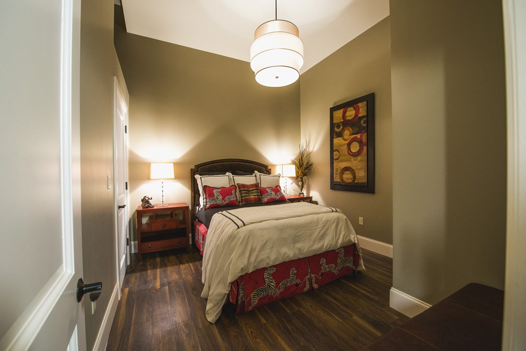 a bedroom with a bed and two nightstands a bedroom with a bed and two nightstands at The Knights @ 506 Delaware Apartments, New York