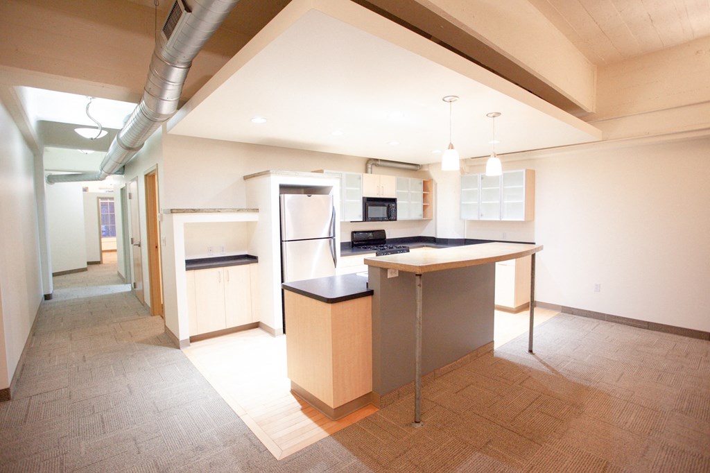 a large kitchen with an island in the middle of it