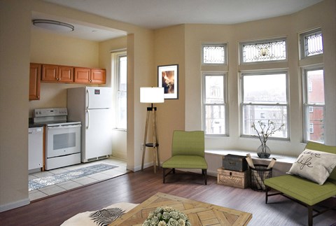 an open living room with a kitchen and a table