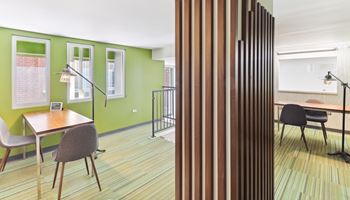 a living room and a dining room with a table and chairs