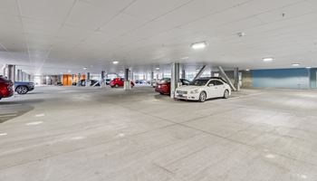 an empty parking garage with cars parked in it Hot Metal Flats apartments, Southside Pittsburgh, PA