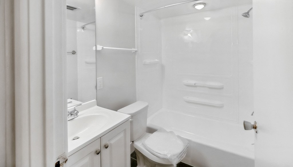 a white bathroom with a shower sink and toilet at Walnut Towers at Frick Park, Pittsburgh, Pennsylvania