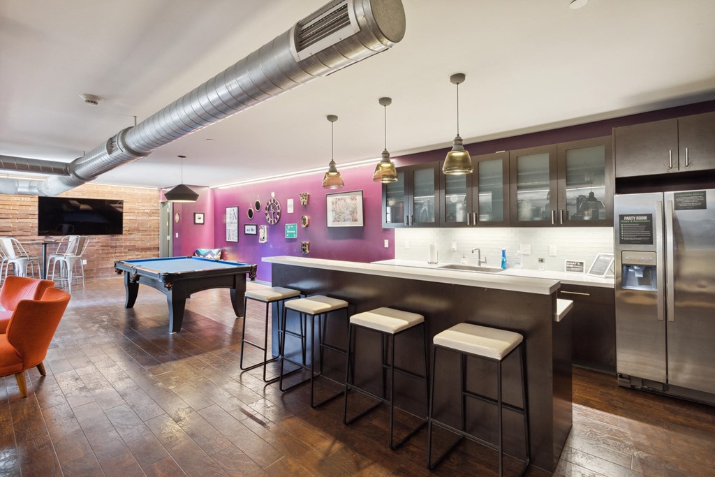A modern kitchen with a pool table and bar stools. at Walnut on Highland, Pittsburgh, PA