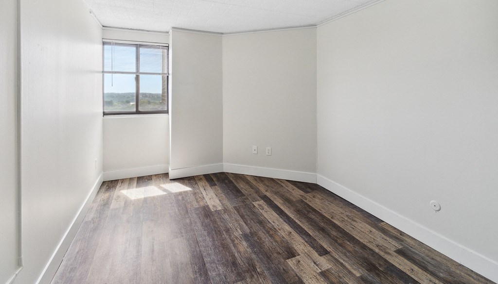 an empty room with wood floor at Walnut Towers at Frick Park, Pittsburgh, PA 15217