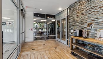 the lobby of a store with glass doors and a wood floor Hot Metal Flats apartments, Southside Pittsburgh, PA
