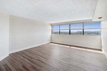 A room with a large window and wooden flooring at Walnut Towers at Frick Park, Pennsylvania