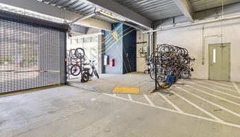 the storage room with bikes and a door