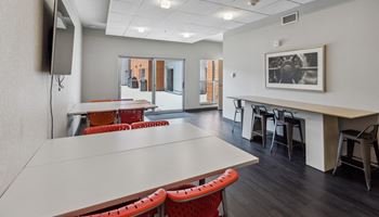 a conference room with tables and chairs and a television Hot Metal Flats apartments, Southside Pittsburgh, PA