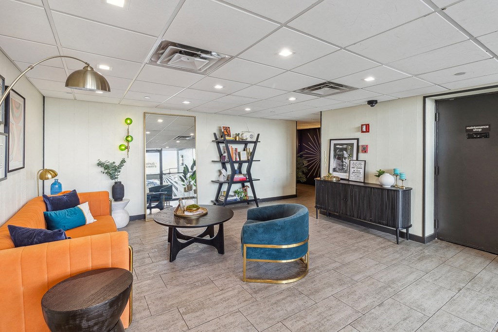 A living room with a sofa, a coffee table, and a bookshelf at Walnut Towers at Frick Park, Pittsburgh, PA 15217