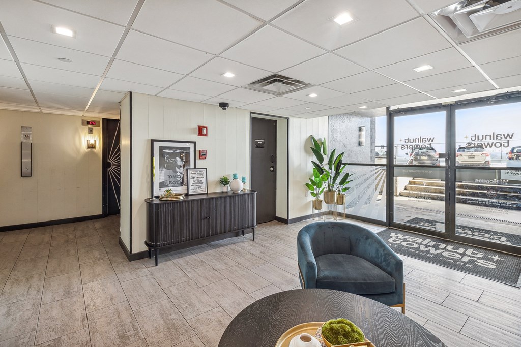A modern office lobby with a reception desk and a chair at Walnut Towers at Frick Park, Pittsburgh, Pennsylvania