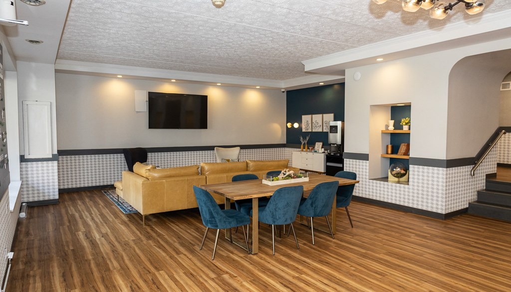 a living room with a couch and a table with chairs
