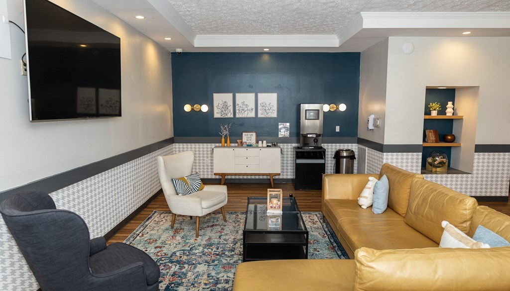 a living room with a brown couch and a black coffee table