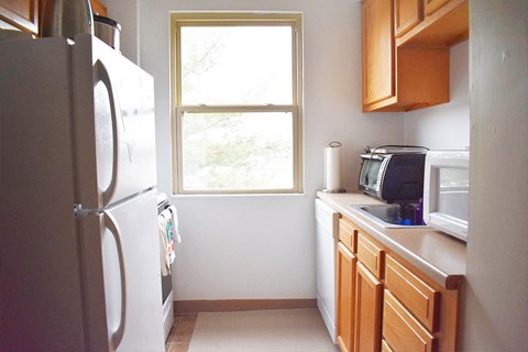 a small kitchen with a refrigerator and a window