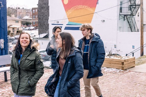 a group of people standing in front of a building at University Commons Apartments, Oakland, Pittsburgh
