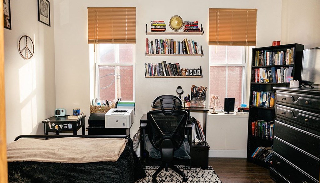 a bedroom with a bed and a baby chair