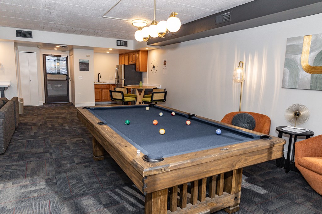 A pool table in a room with a couch and a fan at Walnut Towers at Frick Park, Pennsylvania 15217
