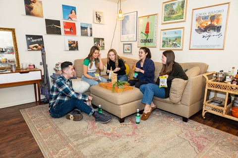 a group of people sitting on a couch in a living room at University Commons Apartments, Oakland, Pittsburgh