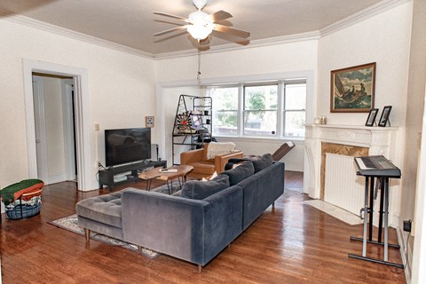 A living room with a grey couch and a television.