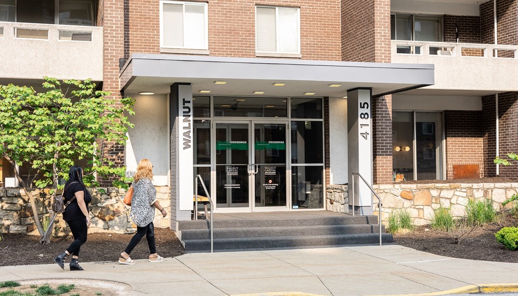 people walking in front of a building