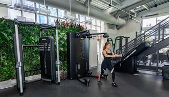 a woman is running on a treadmill in a gym
