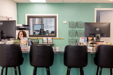 a woman sitting at a desk in front of a computer at University Commons Apartments, Oakland, Pittsburgh