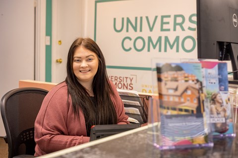 a woman sitting at a desk in front of a computer at University Commons Apartments, Oakland, Pittsburgh