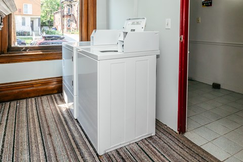 A white counter with a printer on it in a room.
