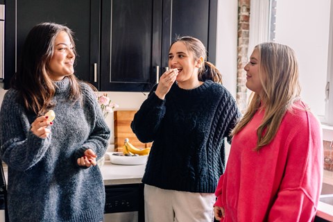 a group of women eating ice cream in a kitchen at University Commons Apartments, Oakland, Pittsburgh