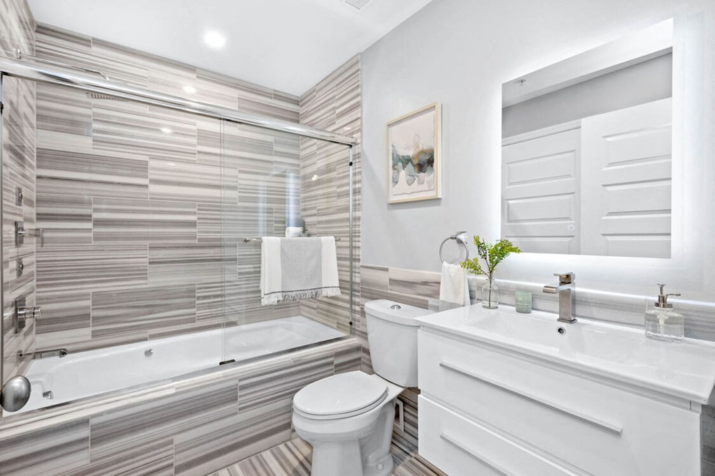 a bathroom with a white toilet next to a bathtub at The Washington at Chatham, Pittsburgh, 15219