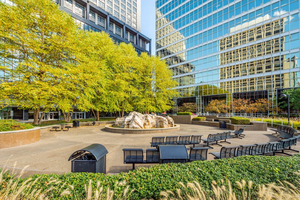 a park with a fountain and benches in front of skyscrapers at The Washington at Chatham, Pittsburgh, PA