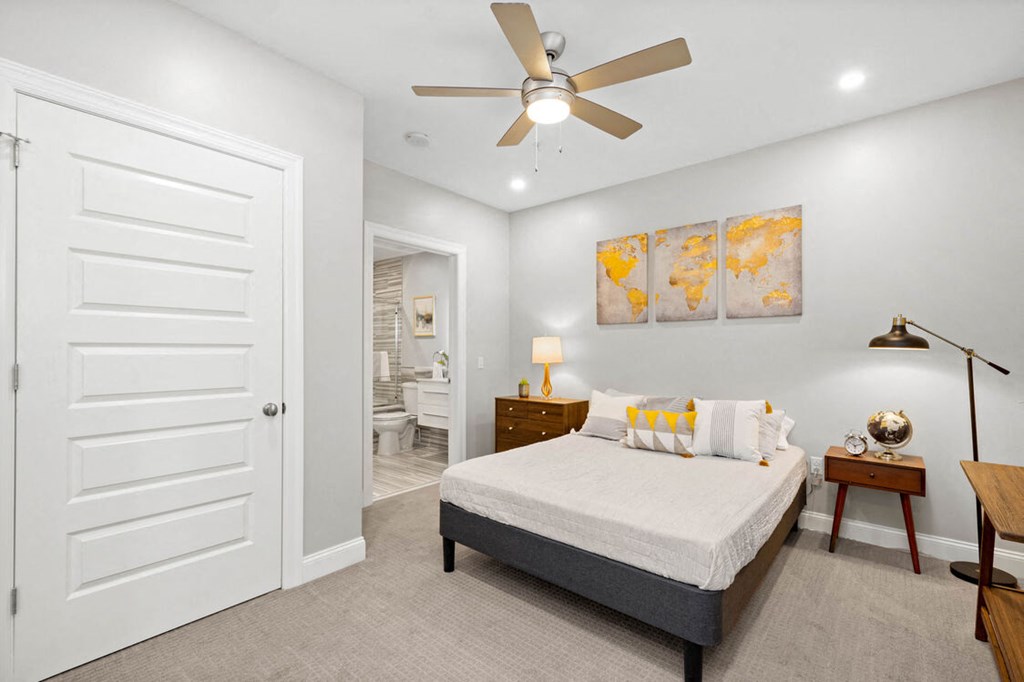 a bedroom with a large bed and a ceiling fan a bedroom with a large bed and a ceiling fan at The Washington at Chatham, Pittsburgh, 15219