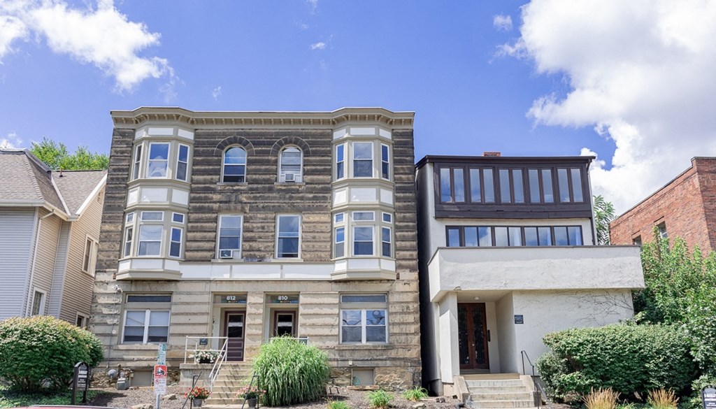 a two story building with a blue sky in the background