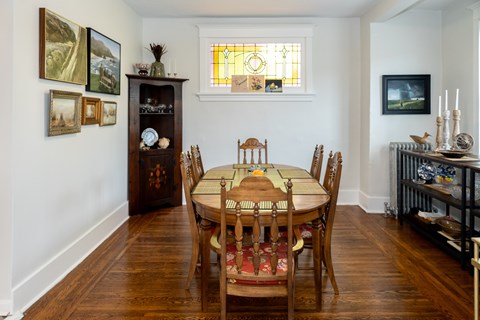 A dining room with a table set for six.