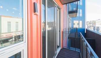 a balcony with a view of the city
