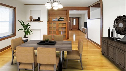 a dining room with a wooden table and chairs