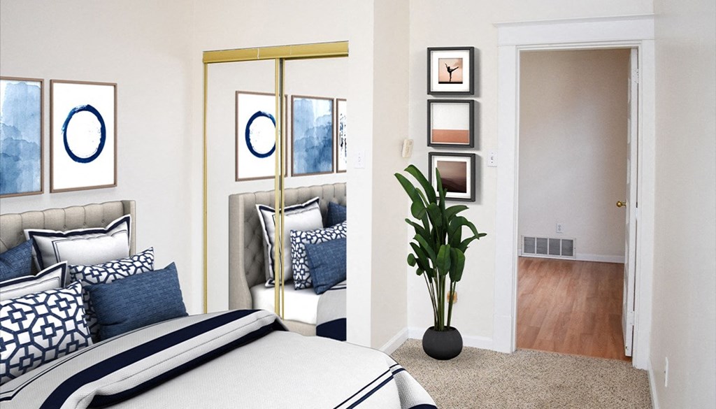 a bedroom with a large bed with blue and white bedding and a large potted plant