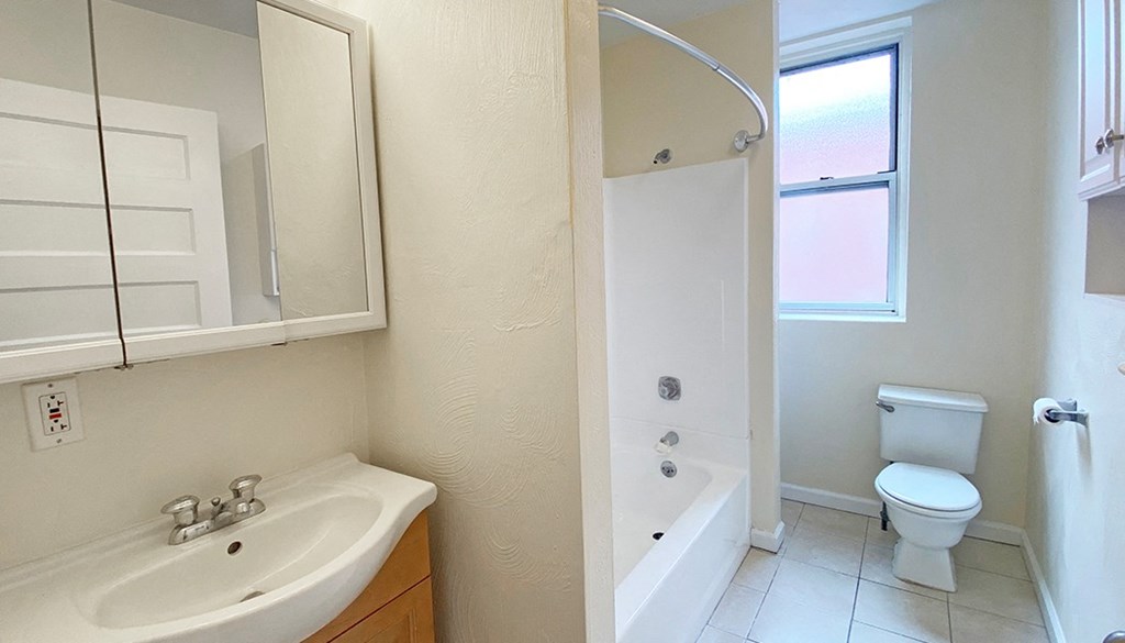 a bathroom with a sink toilet and bathtub