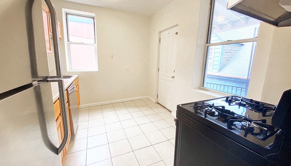a kitchen with a stove and a refrigerator