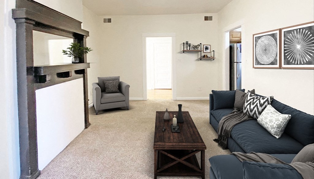 a living room with a black couch and a wooden coffee table