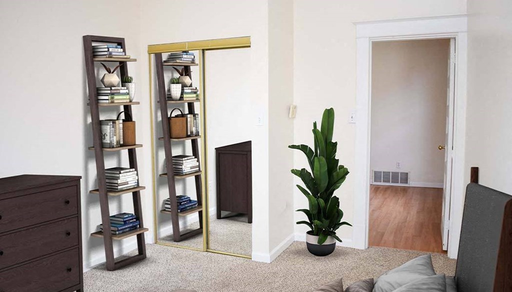 a living room with a plant and a mirror