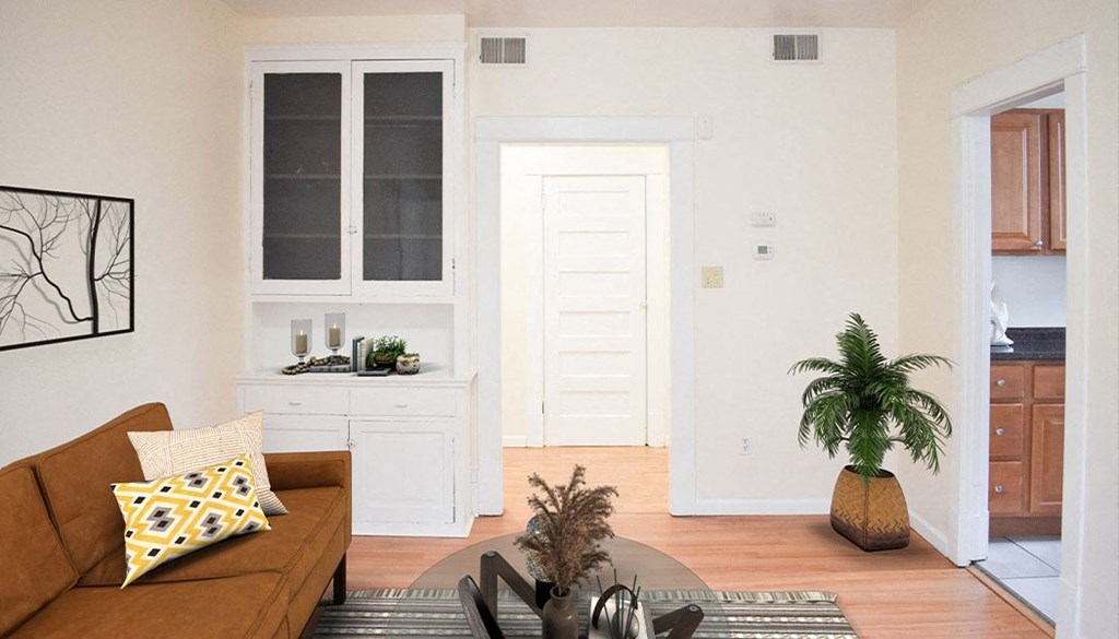 a living room with white walls and a brown couch