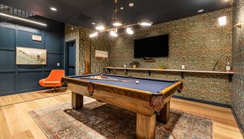 a game room with a pool table and a tv at The Commonwealth Building, Pittsburgh, 15222