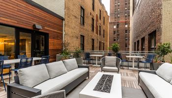 an outdoor patio with couches and chairs and tables at The Commonwealth Building, Pennsylvania
