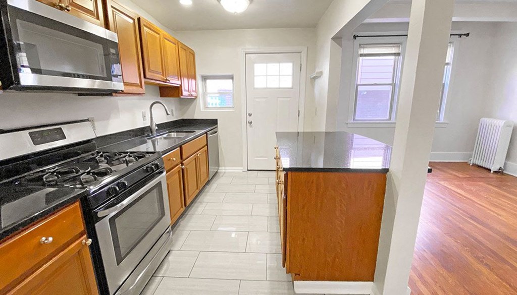 a kitchen with a stove top oven next to a counter