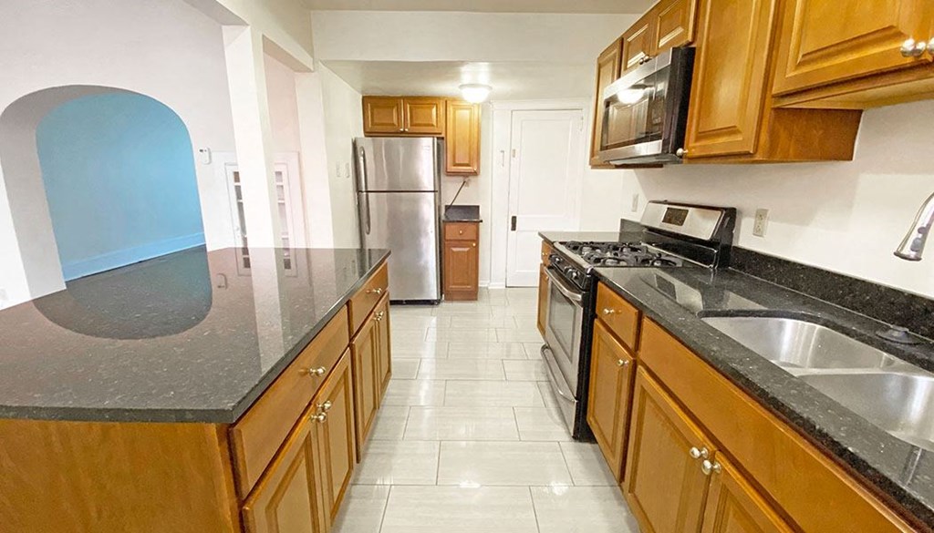 a kitchen with a stove a sink and a refrigerator